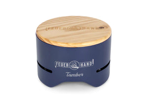 Feuerhand Tamber Table Top Grill in cobalt blue with wooden lid, compact and stylish for outdoor grilling in home and garden settings.
