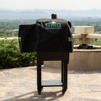 GMG grill cover on outdoor barbecue with scenic background