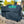 GMG Trek Prime 2.0 grill cover packaging with grill in outdoor setting