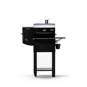 Green Mountain Grills TREK PRIME 2.0 Pellet Grill mounted on stand with side shelf, perfect for backyard BBQ and portable grilling.
