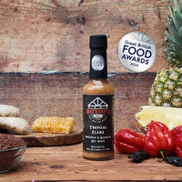 Tropical Flame hot sauce with tropical fruits and award badge
