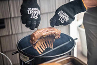Man using Pit Barrel Pit Gloves - FireFly Barbecue to lift ribs from a smoker, showcasing heat protection and non-slip grip for outdoor cooking.