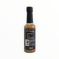 Tropical Flame hot sauce bottle with ingredients and award badge