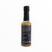 Tropical Flame hot sauce bottle with detailed label and ingredients
