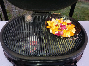 Primo grill with heat deflector and drip pan racks for indirect cooking