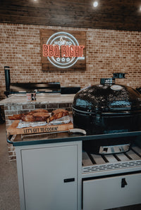Close-up of Primo Kamado Grill with open lid in indoor setting