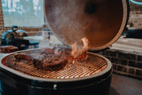 Primo XXL500 Kamado Grill with open lid and flames