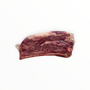 Raw beef short rib with marbling on white background