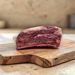 Black Angus beef short ribs on wooden board