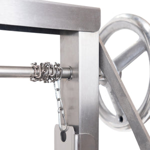 Detail of the crank mechanism on the Bertha Asado Grill Small, allowing precise control of grill height over open flame.