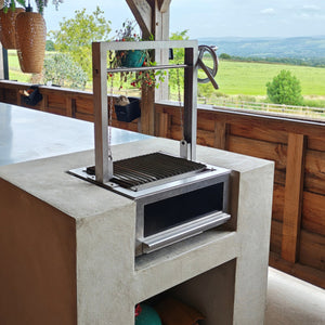 Bertha Asado Grill Small installed in an outdoor kitchen, showcasing its compact design and integration into a built-in countertop setup.