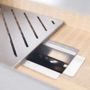 Interior view of Bertha Asado Grill Medium showing slotted stainless steel fire tray and firebrick lining for heat efficiency.