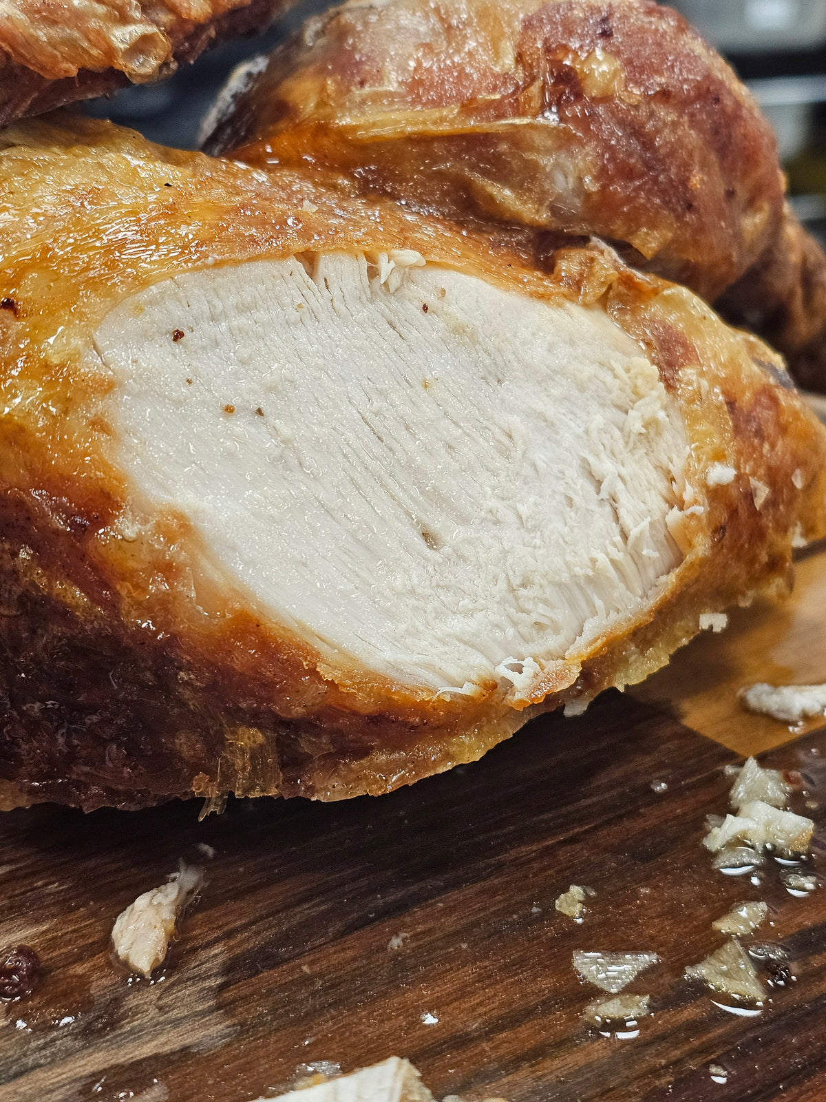 Close-up of juicy, tender turkey breast cooked using the BBQ Bird Brine Kit, showcasing moist texture and golden-brown crust.