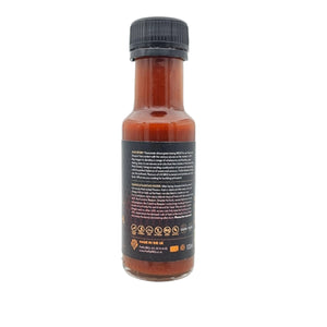 Side view of Carolina Reaper Hot Sauce bottle with brand story and quality certifications. Firefly BBQ's award-winning spicy condiment.