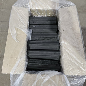 Open box of HazelHex Briquettes 10kg with tightly arranged hexagonal charcoal logs, perfect for outdoor BBQ use.
