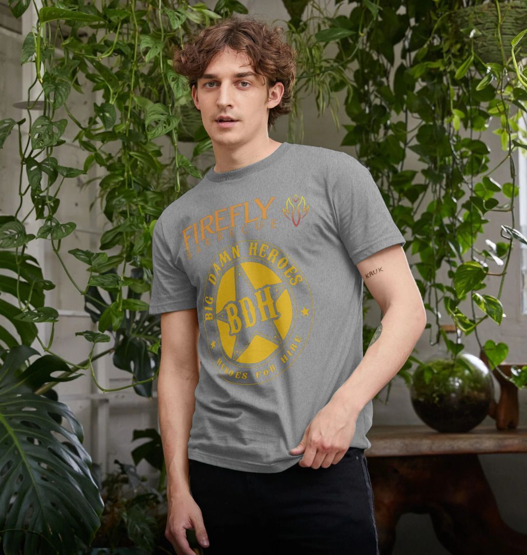 Model wearing black T-shirt with Firefly Big Damn Hero logo in cityscape