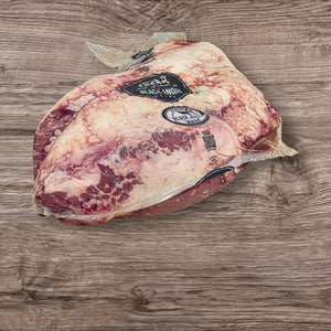 Top view of hormone-free Black Angus brisket by Jack's Creek, showing premium marbling and sealed packaging for gourmet cooking.