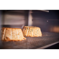 Baked apple slices on stainless steel grill rack in oven