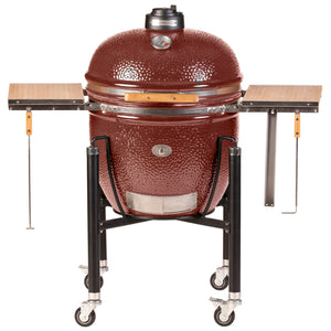 Red Monolith Le Chef Pro Series 2.0 Kamado Grill with side tables and wheeled stand, offering stylish and functional outdoor grilling.