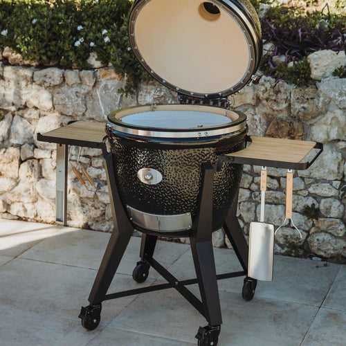 Kamado grill with side tables and wheels for outdoor cooking