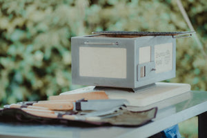 Nano Pro Kasai BBQ Stainless Steel Grill in outdoor setting with utensils, ideal for authentic Japanese grilling experiences at home.