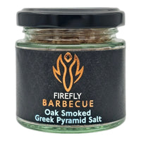 Hand holding oak smoked Greek pyramid salt chunks