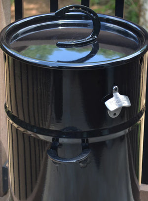 Full view of Pit Barrel Cooker with mounted Pit Barrel Bottle Opener - FireFly Barbecue, essential accessory for outdoor grilling.
