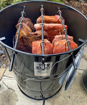Pit Barrel PBX 22.5 Cooker loaded with ribs and brisket hanging on hooks, showcasing large cooking capacity and 360º heat dynamics.