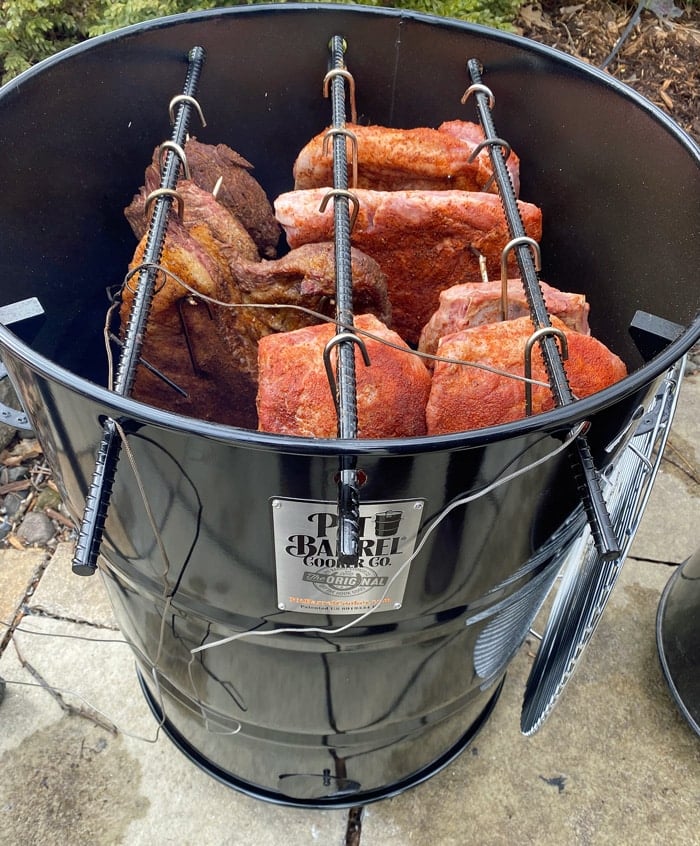 Cooking meat on a Pit Barrel Cooker for outdoor barbecue