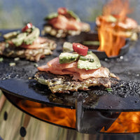 Grilled food with Petromax support ring on outdoor stove