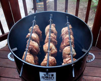 Chicken cooking on Pit Barrel outdoor grill on patio