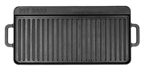 A black cast iron grill pan with a rectangular shape, vertical ridges, and side handles, featuring the 'PIT BOSS' brand name embossed in the top left corner, shown against a plain white background.