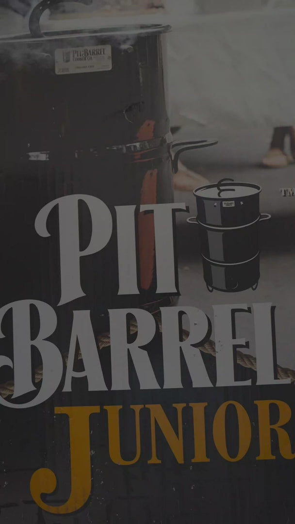 Close-up of Pit Barrel Junior product packaging with bold branding, showcasing the compact smoker and grill for outdoor barbecue enthusiasts.
