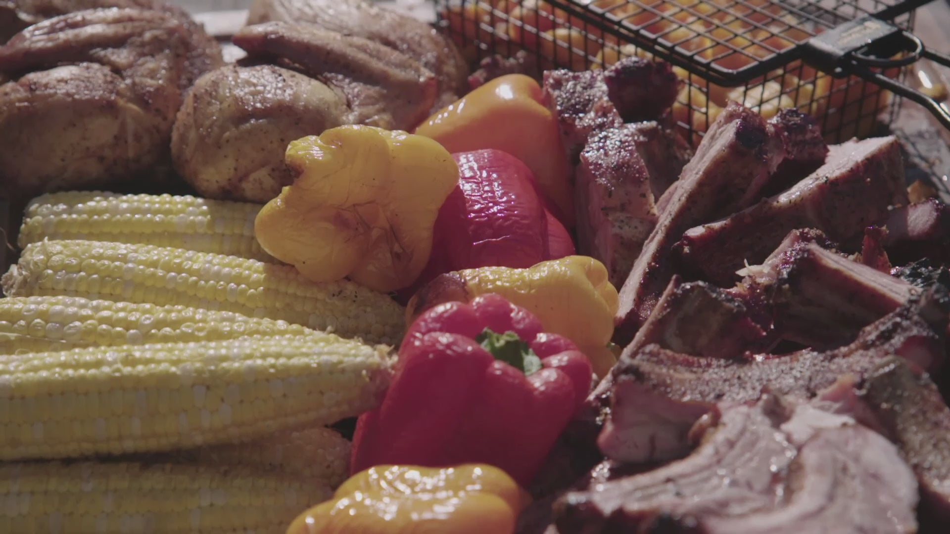 Pit Barrel All-Purpose Basket Hanger - FireFly Barbecue filled with grilled vegetables, corn, and meats, ideal for outdoor cooking variety.