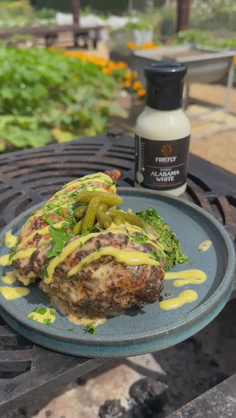 Alabama White BBQ Sauce bottle on outdoor table