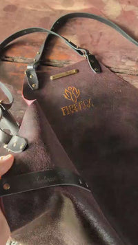 Leather apron with cross straps and logo detail