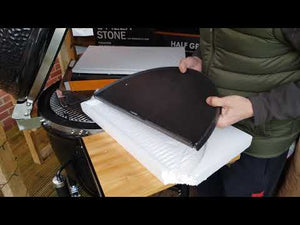 User holding Monolith LeChef cast iron plancha half for Smart Grid System, showcasing its fit and design for outdoor ceramic grill setups.