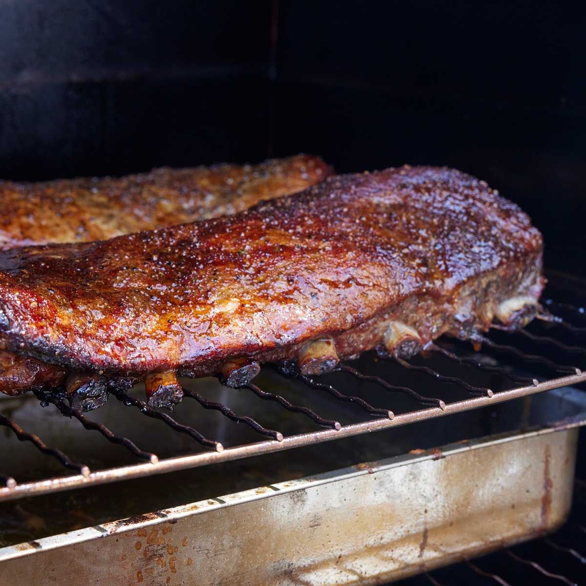 Cooking meat on a grill with a stainless steel Borniak smoker grate, high heat, outdoor barbecue