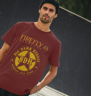 Mens Big Damn Hero Shirt - Firefly | Organic Cotton Tee in maroon worn by model, showcasing bold yellow BDH logo and Firefly Barbecue design, sustainable fashion.