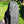 Charcoal pieces in open bag with green grass background, outdoor setting