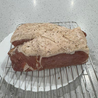 Raw pork belly prepared for curing with seasoning