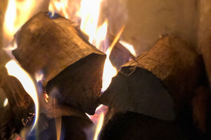 Big K British Oak Logs burning with strong flames, showcasing their high caloric value and suitability for cooking or heating.