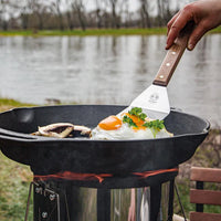 Cooking eggs on cast iron skillet outdoors