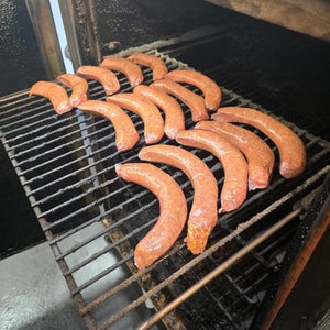 Row of texas hot link sausages on a grill
