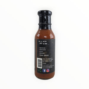 Close-up of sauce bottle with black cap and label