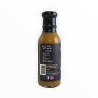 Bottle of Waz's Sauce Island Breeze Mango Sauce with awards