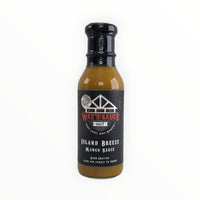 Black cap on mustard-colored sauce bottle