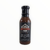 Black bottle of Waz's Sauce Honey Rum Chipotle BBQ