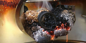 Close-up of Borniak Smoke Generator Stainless Steel - FireFly Barbecue in action, burning wood chips to produce smoke for outdoor grilling.