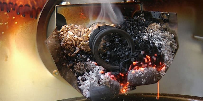 Wood chips burning in a smoker for flavor